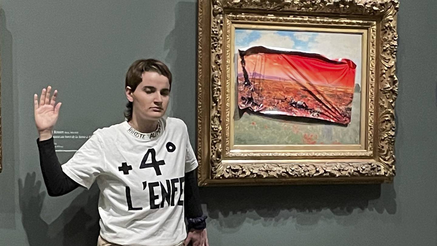A climate activist in Paris stuck a protest poster on Monet